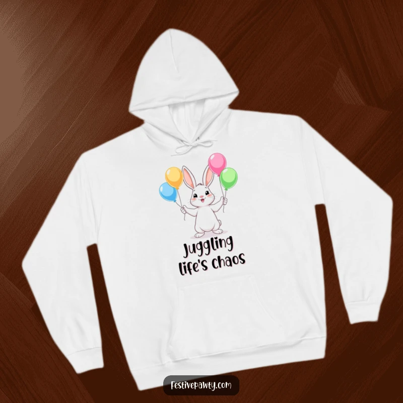 Funny Rabbit Hoodie, a warm sweatshirt featuring a cute rabbit character juggling colorful balloons with all four paws, bringing joy.