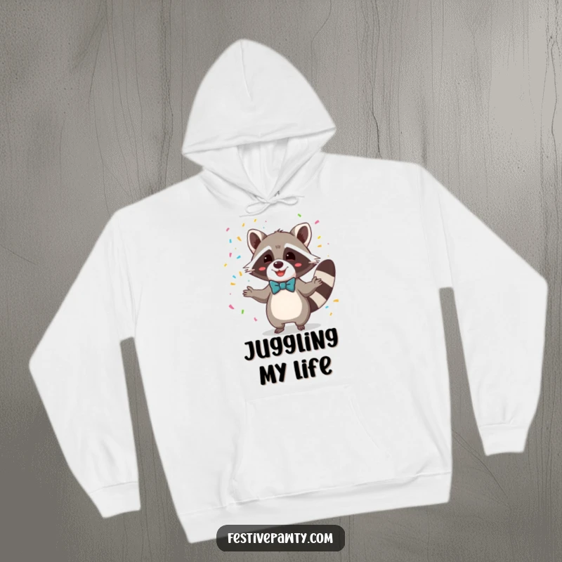 Funny hoodie showcasing a cheerful raccoon in a formal bowtie, juggling a cascade of colorful confetti, a great gift.
