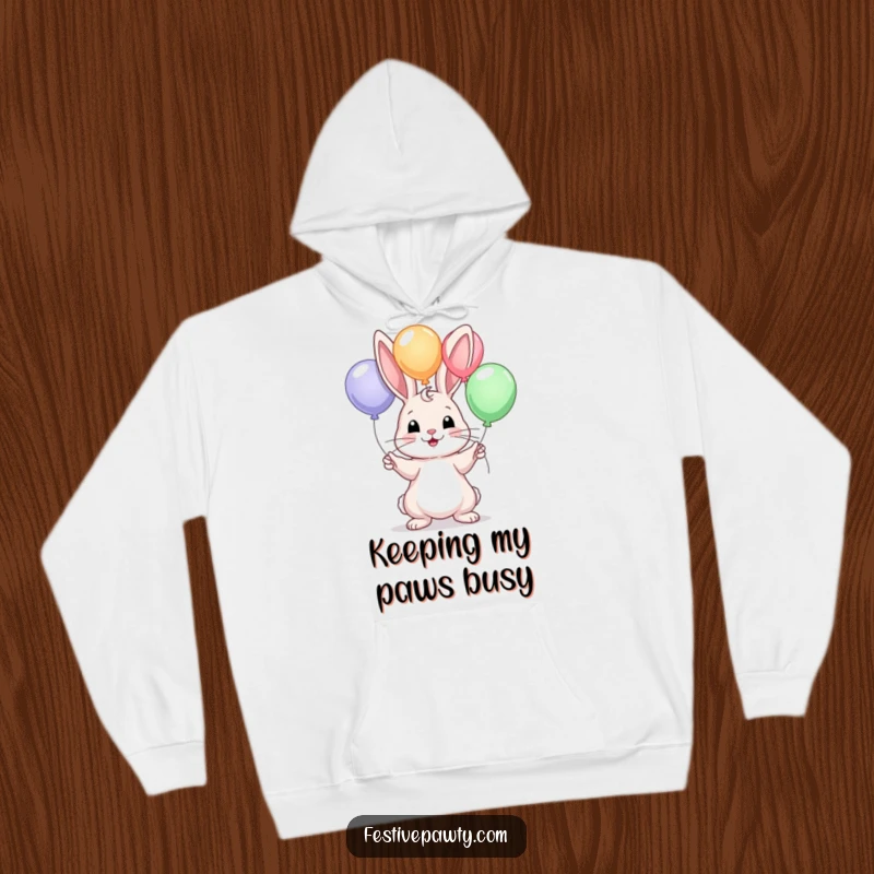 Funny hoodie depicting a cute rabbit skillfully juggling colorful balloons, offering comfort and a humorous vibe.