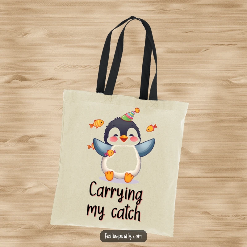 Funny penguin tote bag showing a fluffy penguin juggling colorful fish, ideal for carrying party supplies.