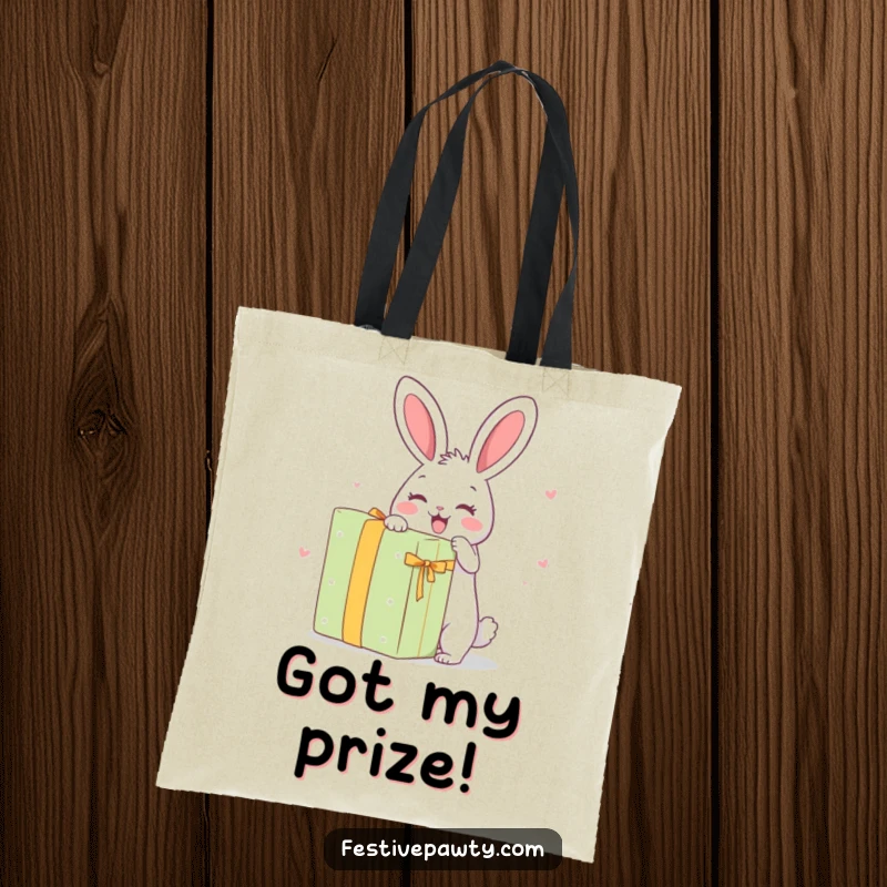 Funny Tote Bag: A delighted rabbit character in the process of unwrapping a comically large gift.
